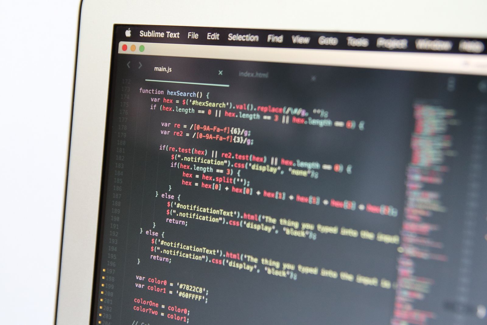Close-up of a laptop screen showing JavaScript code open in the Sublime Text editor