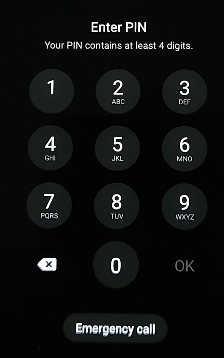 An Android lock screen asking the user to enter a PIN, with a numeric keypad and an Emergency call button