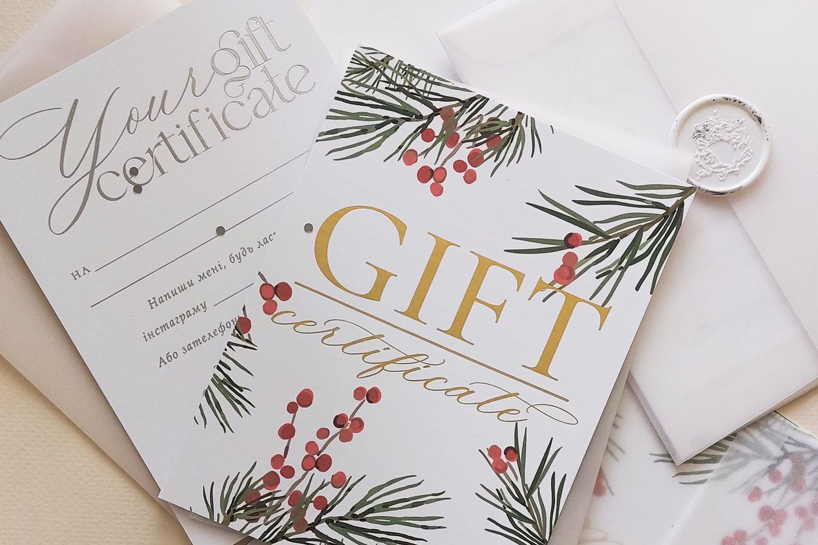 Holiday gift certificates in envelopes with wax seals and pine branch illustrations