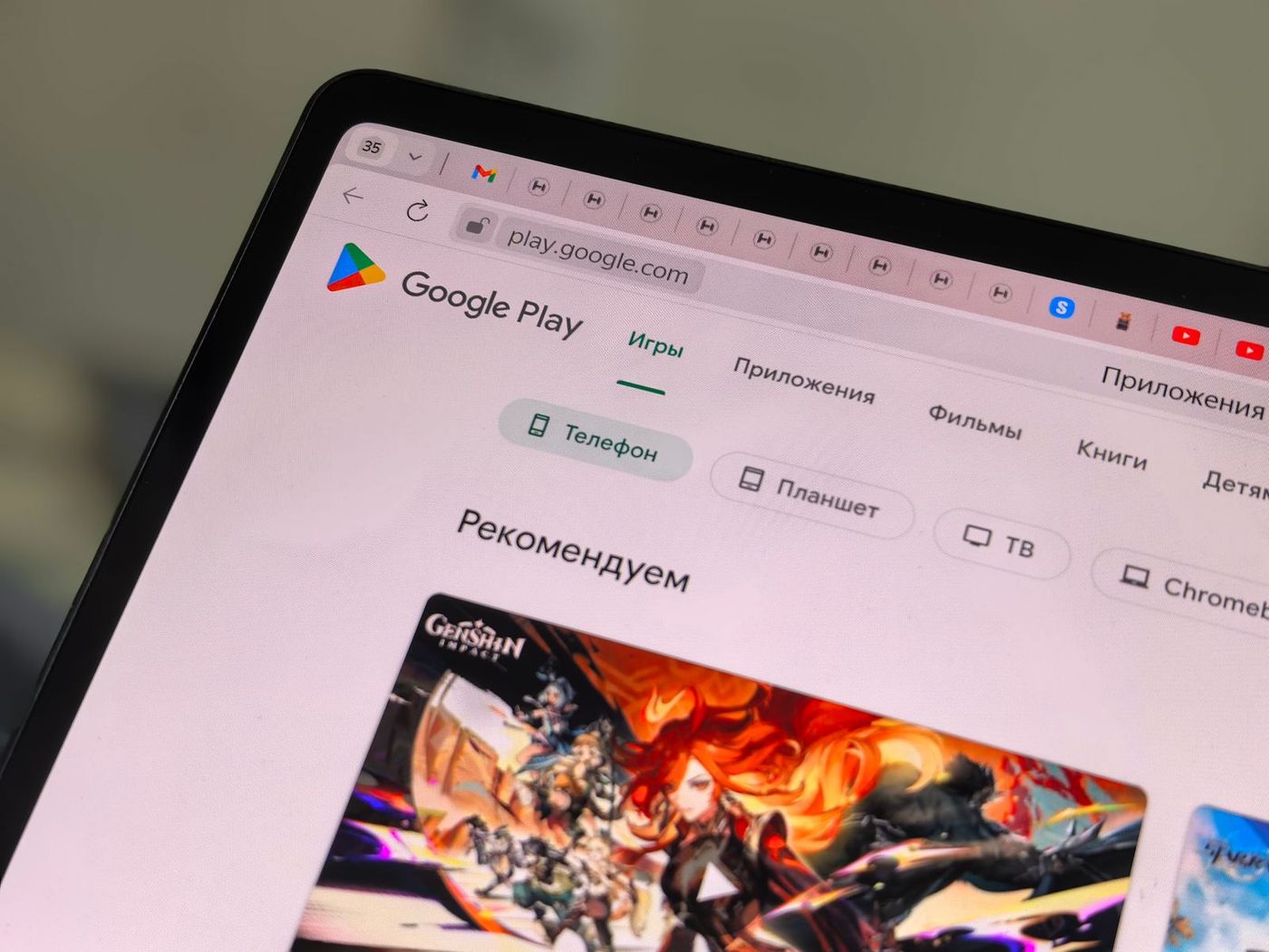 A tablet showing the Google Play Store in a browser, with category tabs and a recommended games banner